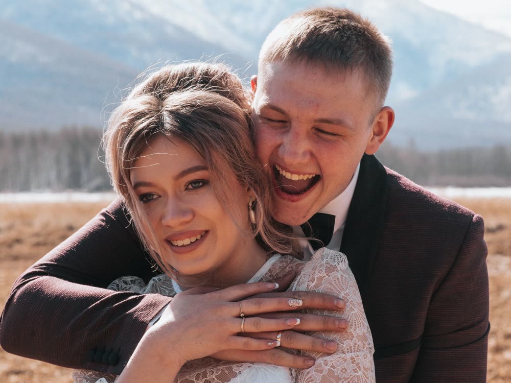 A couple laughing together on their wedding day